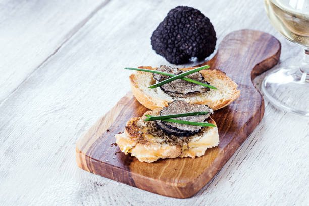 italian black truffle bruschetta with herbs and oil on grilled or toasted crusty ciabatta bread - appetizer bruschetta meal lunch imagens e fotografias de stock