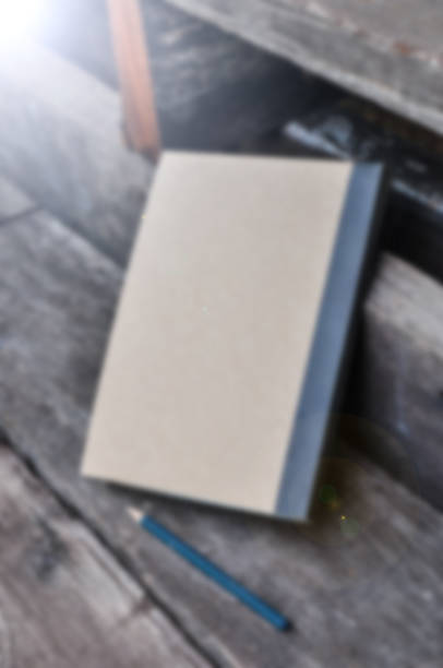 istock blur note book on wooden background ,Vintage tone filter effect color style 837212234