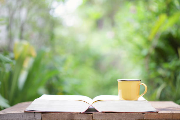 istock Yellow mug and book at outdoor 837217814