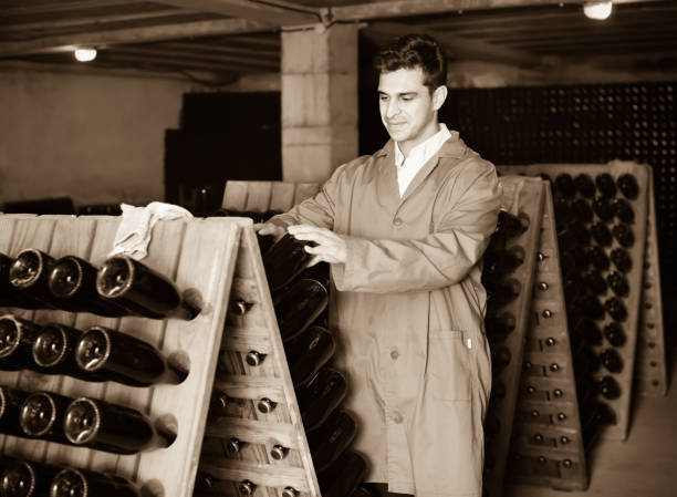 istock Man winery   working in aging section with bottle racks in cellar 837218870