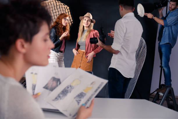 istock Fashion models talking with photographer 837219174
