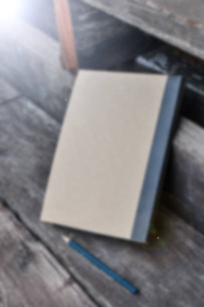 istock blur note book on wooden background ,Vintage tone filter effect color style 837219492