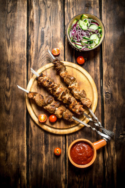 istock Kebab with fresh salad of cucumbers and onions. 837220446