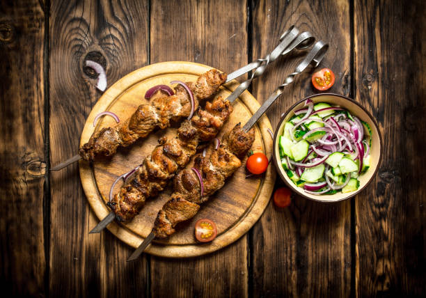 istock Kebab with fresh salad of cucumbers and onions. 837225794