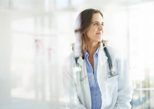 With her, good health is in sight Shot of a mature doctor looking thoughtful in a consulting room good doctor photos stock pictures, royalty-free photos & images
