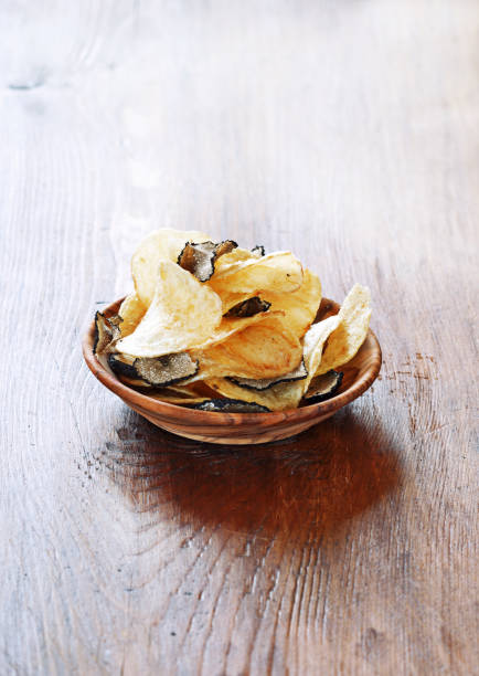 istock Crispy potato chips in a wooden bowl. 837228680