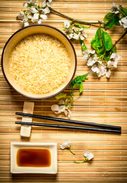 istock Bowl with rice, soy sauce and the cherry branches. 837228836