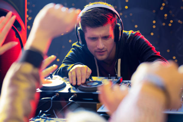 Focused DJ playing Young handsome focused DJ playing at the club dance  electronic music photos stock pictures, royalty-free photos & images