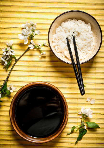 istock Boiled rice with soy sauce and the cherry branches 837236624