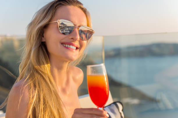 istock Young woman drinking in a hotel terrace 837237220