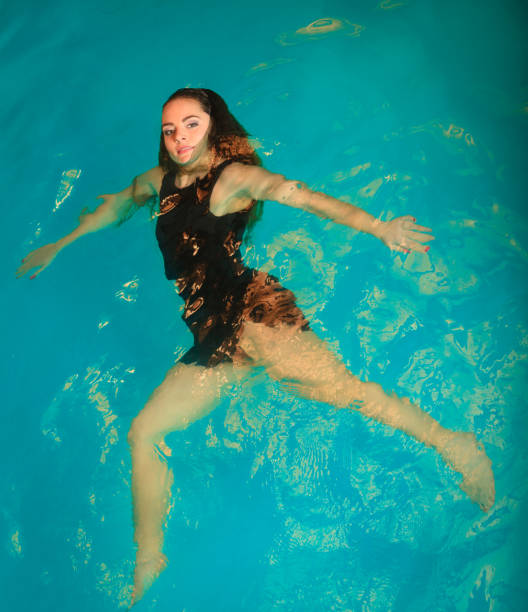 istock Woman floating relaxing in swimming pool water. 837243698