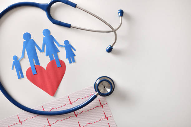 Electrocardiogram stethoscope and cutout heart on white table top