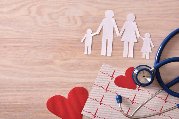 istock Electrocardiogram stethoscope and cutouts on wood table top view 837245840