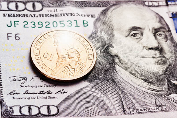 istock American one-dollar coin on $100 banknote 837256440