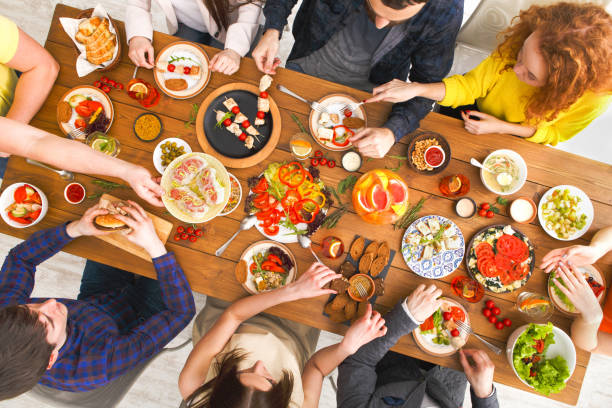 istock People eat healthy meals at served table dinner party 837282186