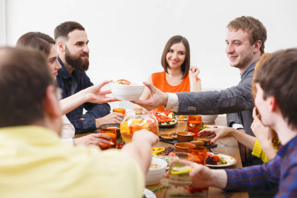 istock Group of happy people at festive table dinner party 837282524