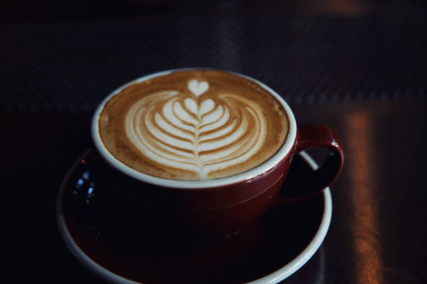 istock Cappuccino coffee on coffee bar in dark tone 837284416