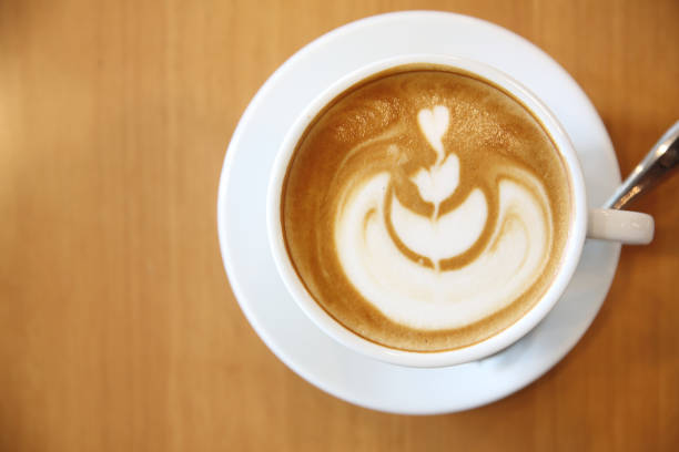 istock cappuccino coffee on wood background 837290302