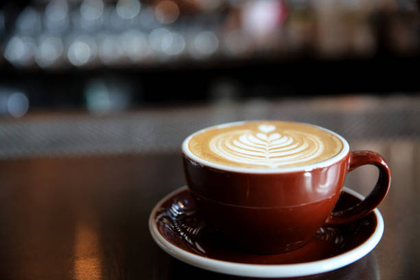 istock Cappuccino coffee on coffee bar in dark tone 837291364
