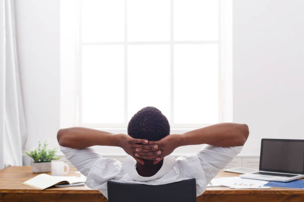 istock Relaxed black businessman with laptop in modern white office 837301662