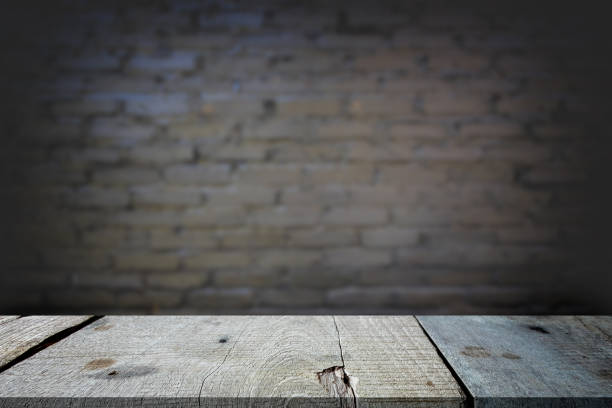 istock Selected focus empty gray wooden table and wall texture or old black brick wall blur background image. for your photomontage or product display 837304444