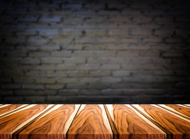 istock Selected focus empty brown wooden table and wall texture or old black brick wall blur background image. for your photomontage or product display 837305174