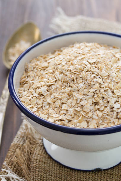 istock oat on white bowl on wooden background 837316704