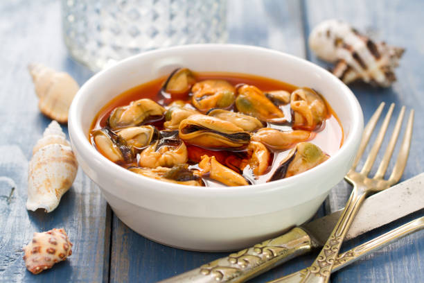 istock mussels with sauce in white dish on blue background 837318246