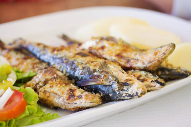 istock grilled sardines with potato and salad on dish 837320972