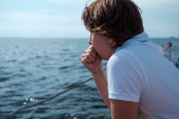 istock Young woman suffer from seasickness during vacation on boat 837321624