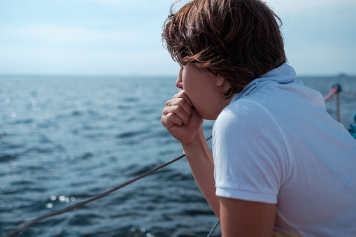 Young woman suffer from seasickness during vacation on boat or yacht