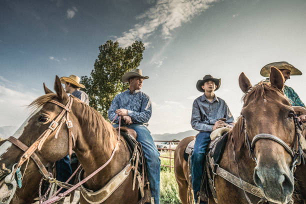 istock Four cowboys horseback riding together. 837322422