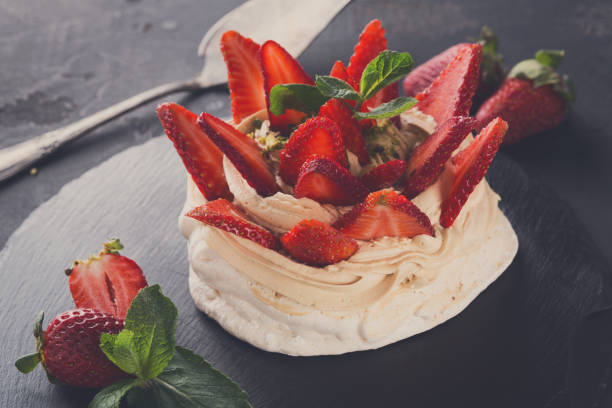istock Anna Pavlova cake with strawberry on black background 837322460