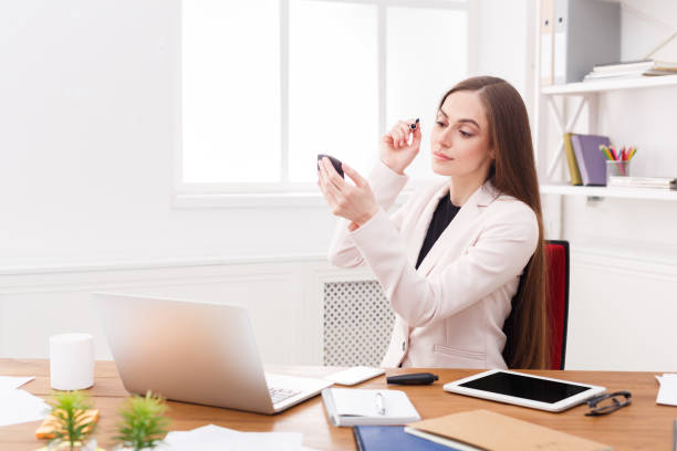 istock Business woman refreshing her makeup at office 837329418