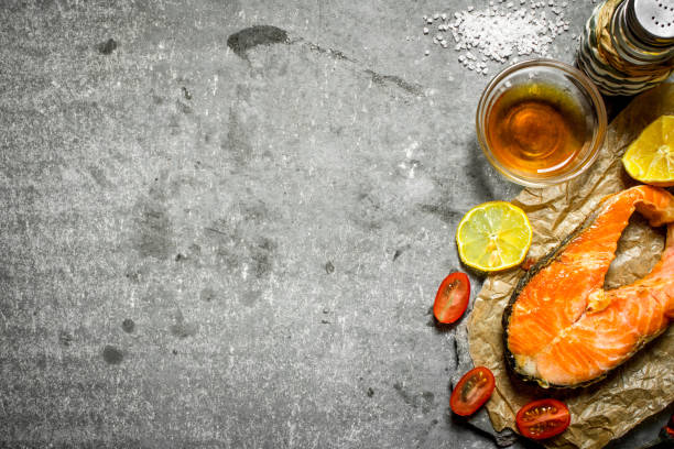 istock Grilled salmon with olive oil, tomatoes, lemon and spices. 837330354
