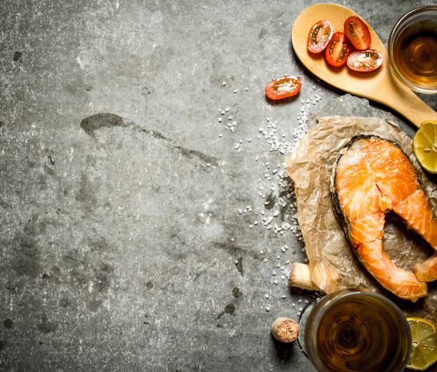 Grilled salmon with olive oil, tomatoes, lemon and spices.
