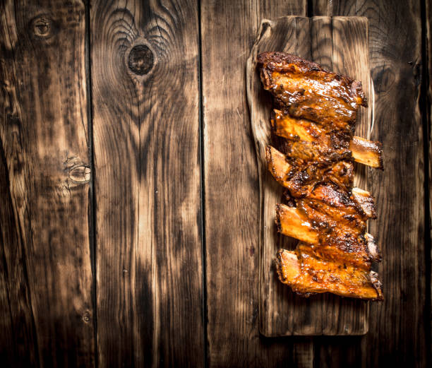 istock Smoked ribs grilled on the old Board. 837330780