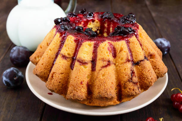 istock Large freshly baked cake with summer berries on a dark wooden table. 837330908