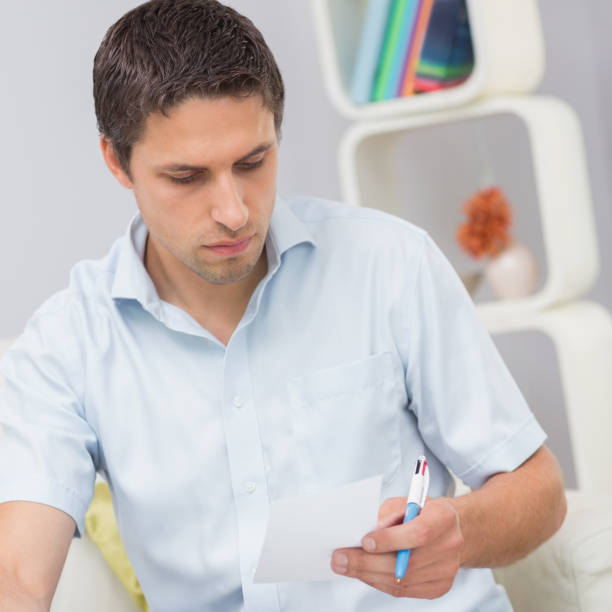 istock Worried young man paying his bills at home 837335866