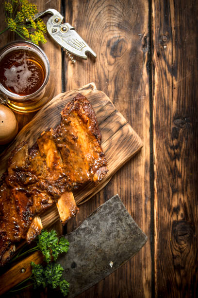 istock Pork ribs grilled with a meat hatchet and beer. 837335908