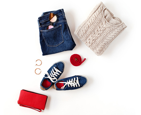 Autumn outfit. Women's fashion clothes and accessories in blue and red colors isolated on white background. Flat lay, top view.