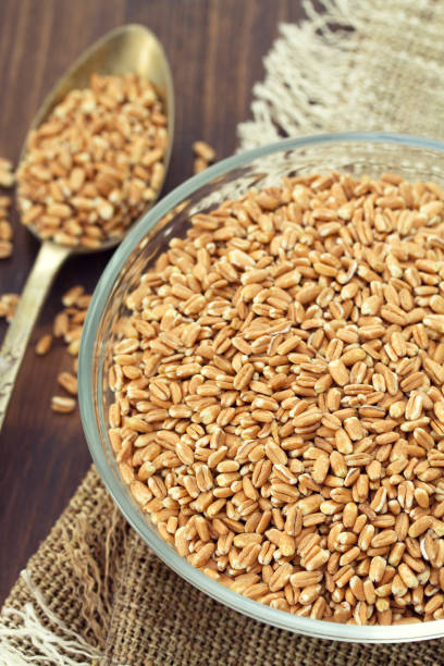 istock raw spelt on wooden background 837337534