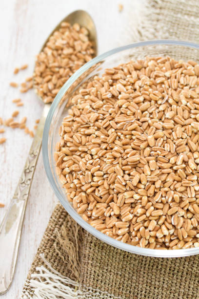 istock raw spelt on wooden background 837337564