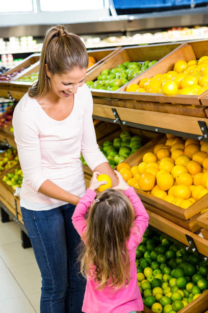 istock Mother and daughter taking fruit 837344366