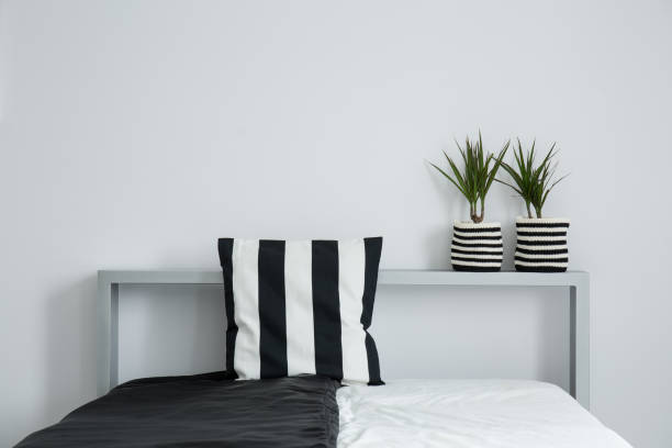 istock Striped pillow on black and white coverlet 837344824