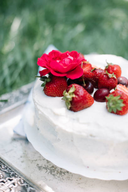 istock Delicious rustic hand made white fluffy cake with fresh strawberries and cherries on the top. 837345334