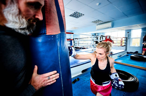 istock Strong young woman training with her coach 837345580
