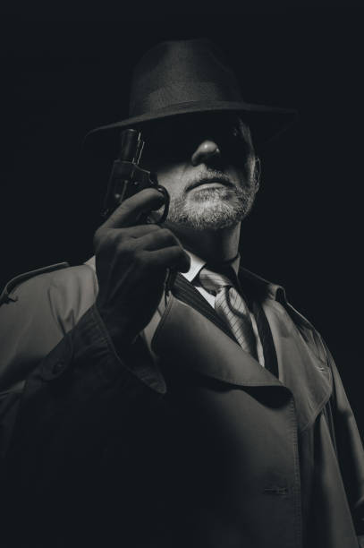 istock Detective holding a gun in the dark 837345764