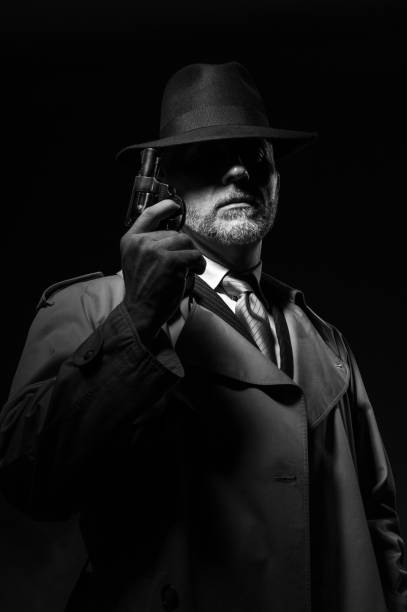 istock Detective holding a gun in the dark 837349030