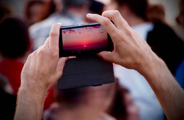 istock Man´s hands taking photo of the beautiful sunset 837349580